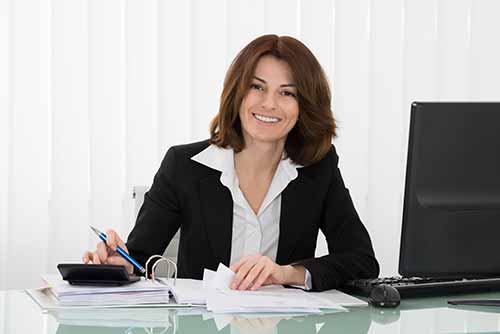 Happy Employee In Black Sleeve Calculating Tax At The Desk.